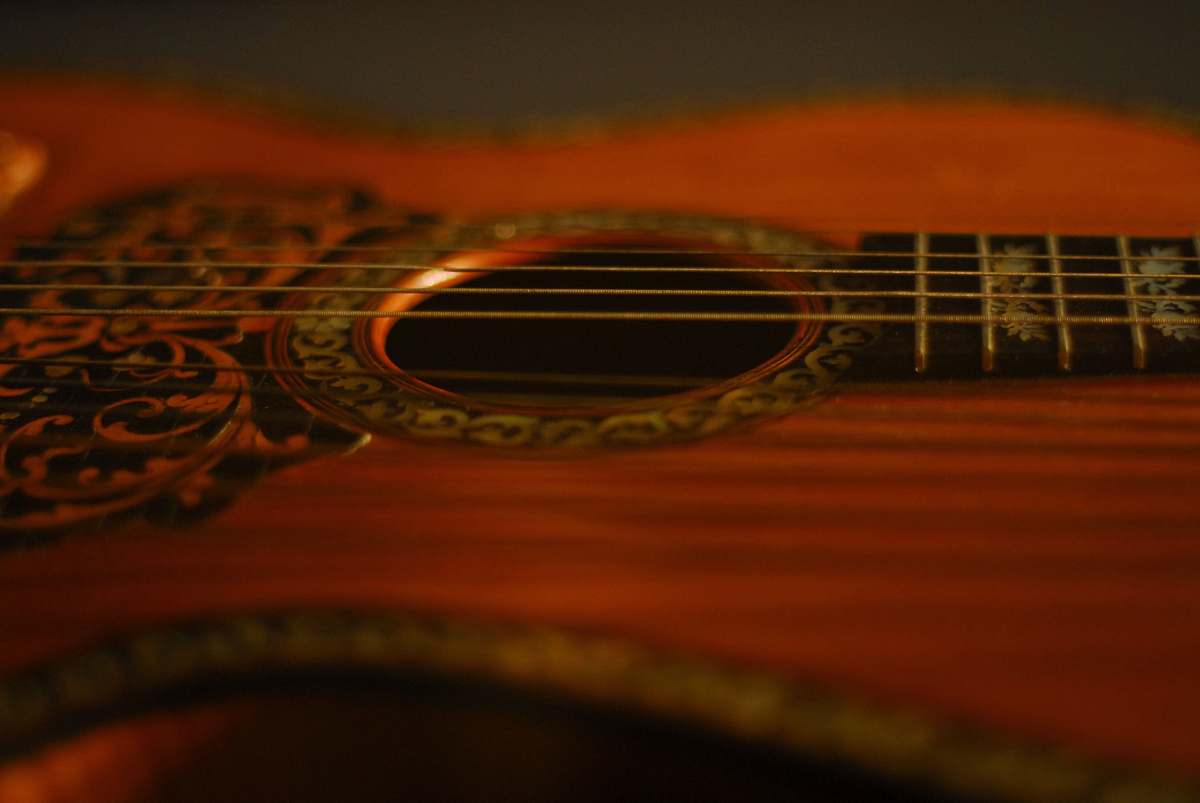 leisure activities red acoustic guitar musical instrument